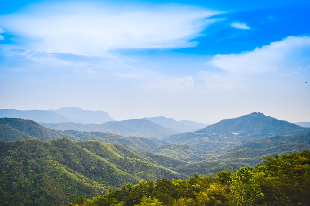 a scenic view of a mountain range with a blue sky