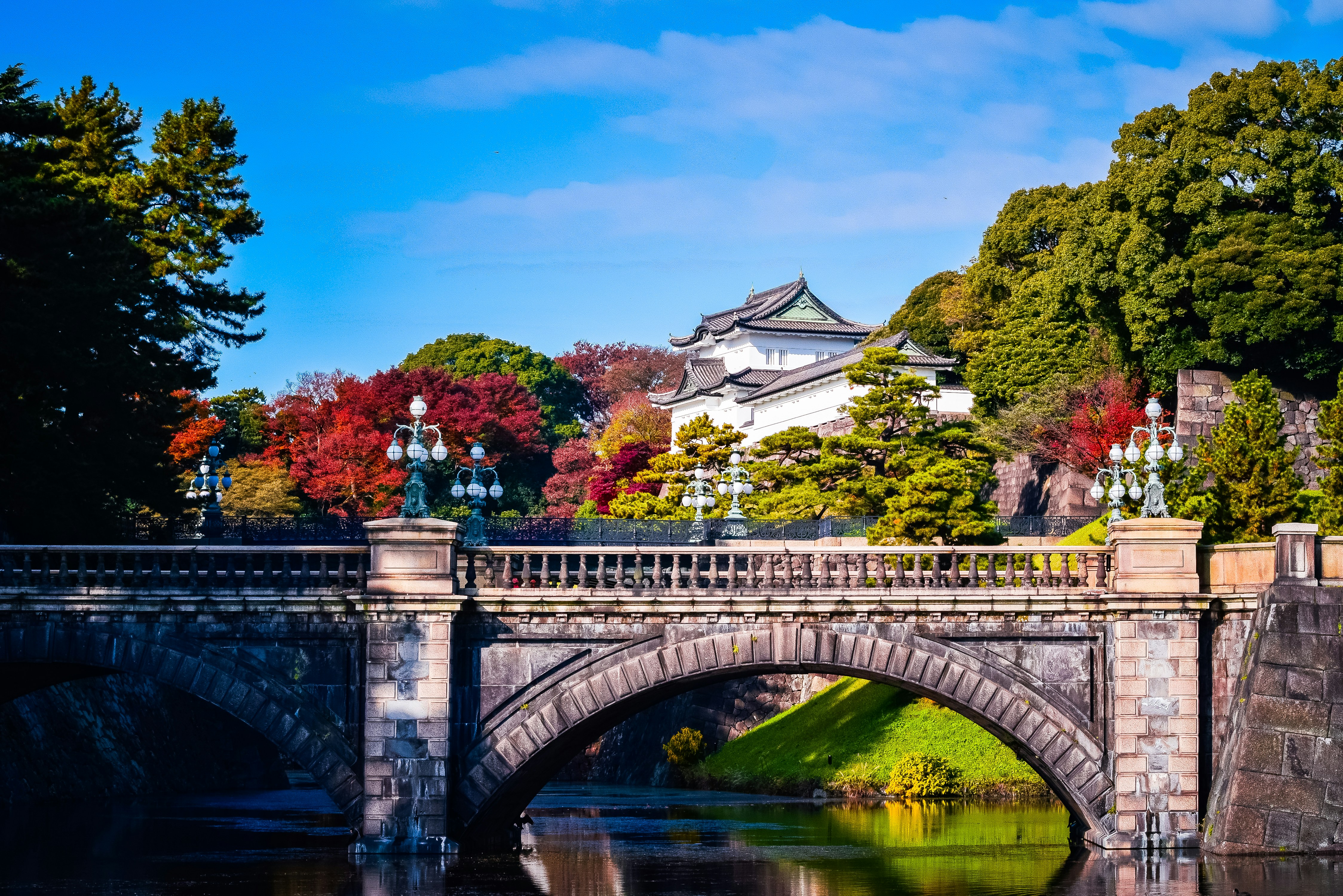 a bridge over a body of water with a building in the background