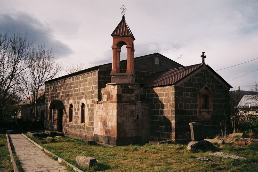 an old church with a steeple and a cross on top