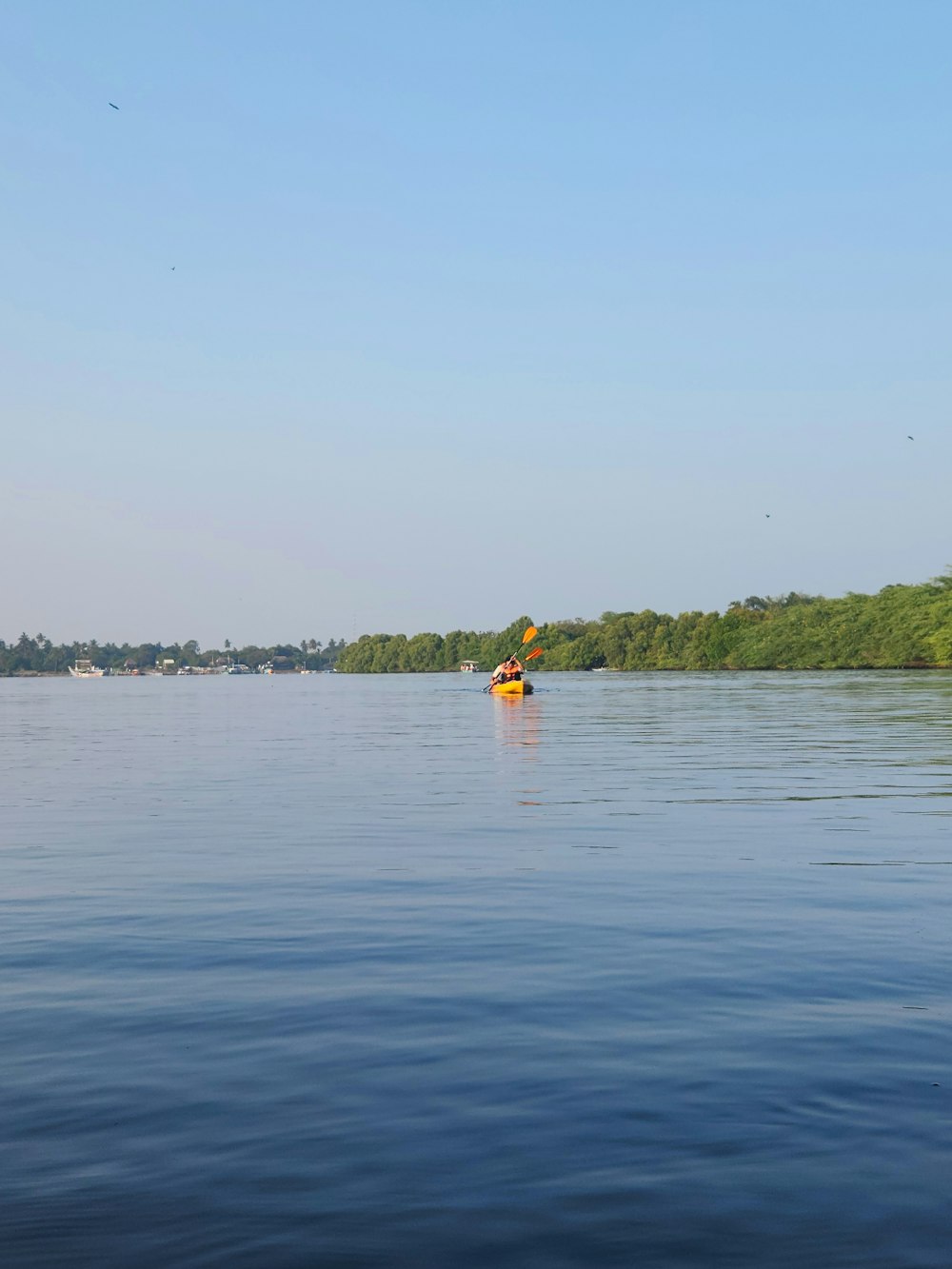 a person paddling a kayak on a calm lake