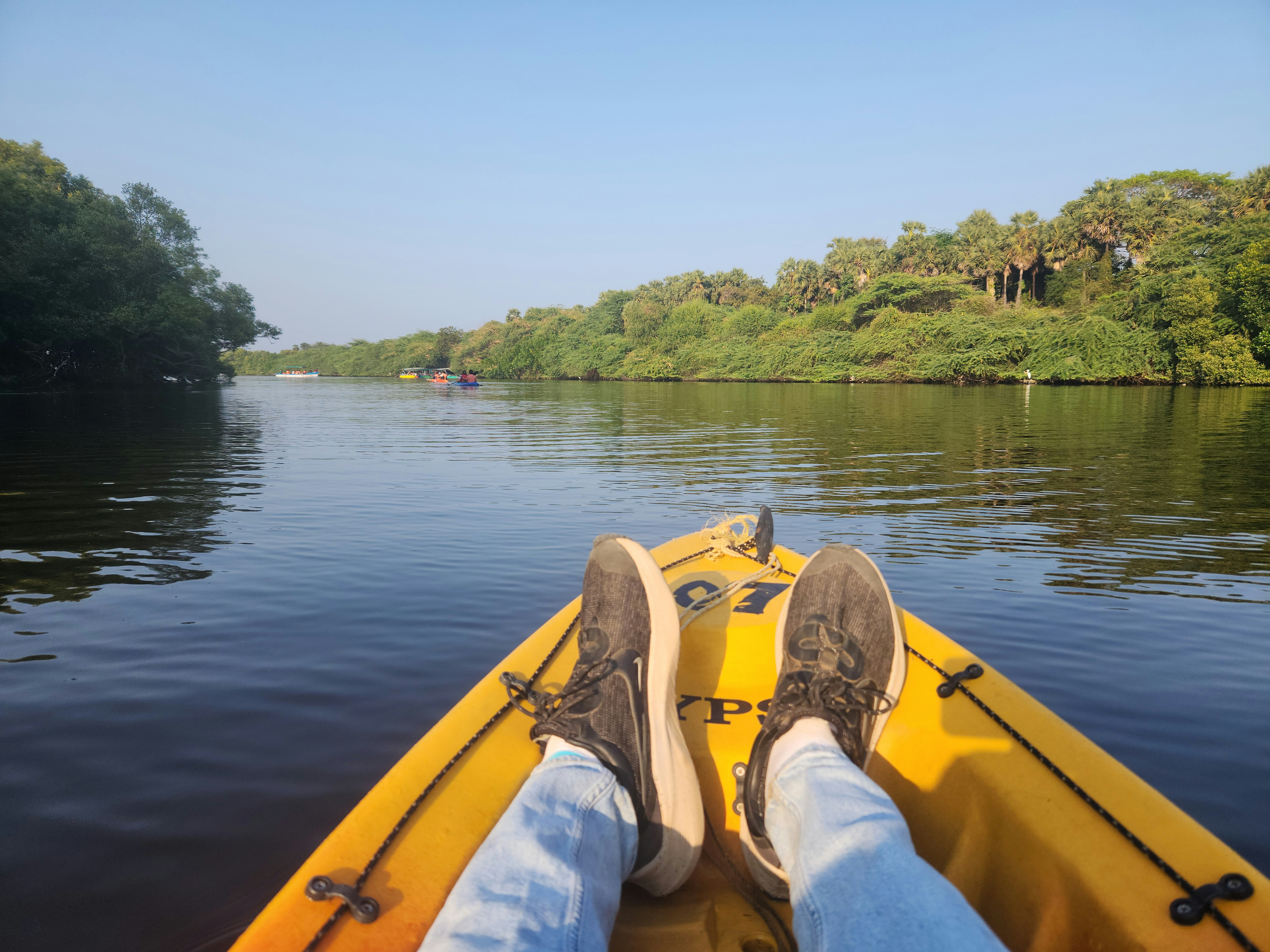 a person sitting in a yellow boat on a river
