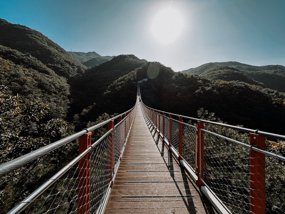 a wooden walkway in the middle of a mountain