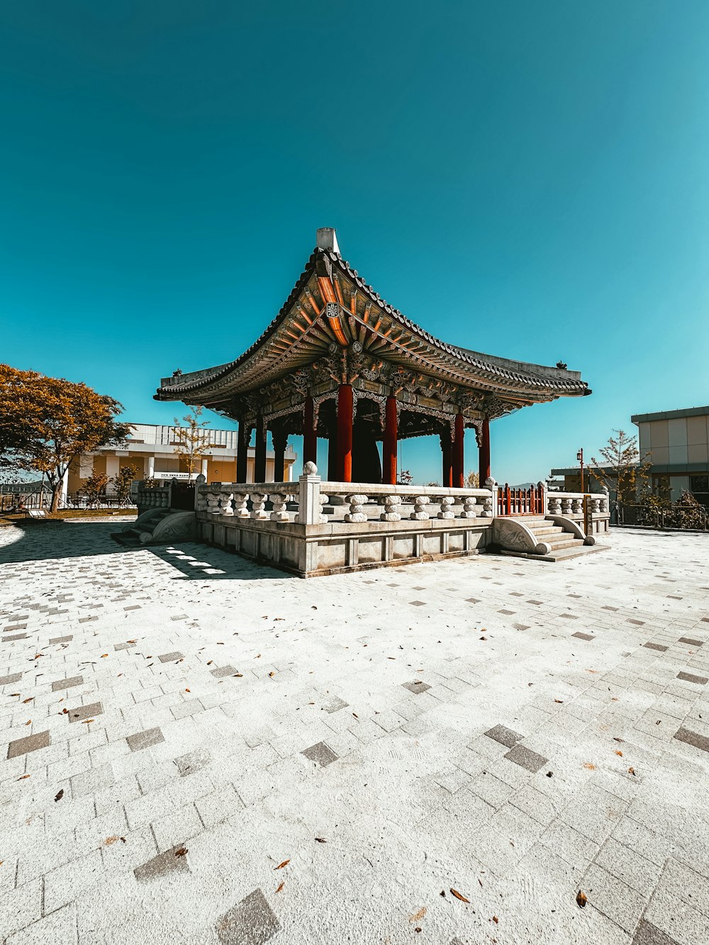 a gazebo sitting on top of a stone walkway