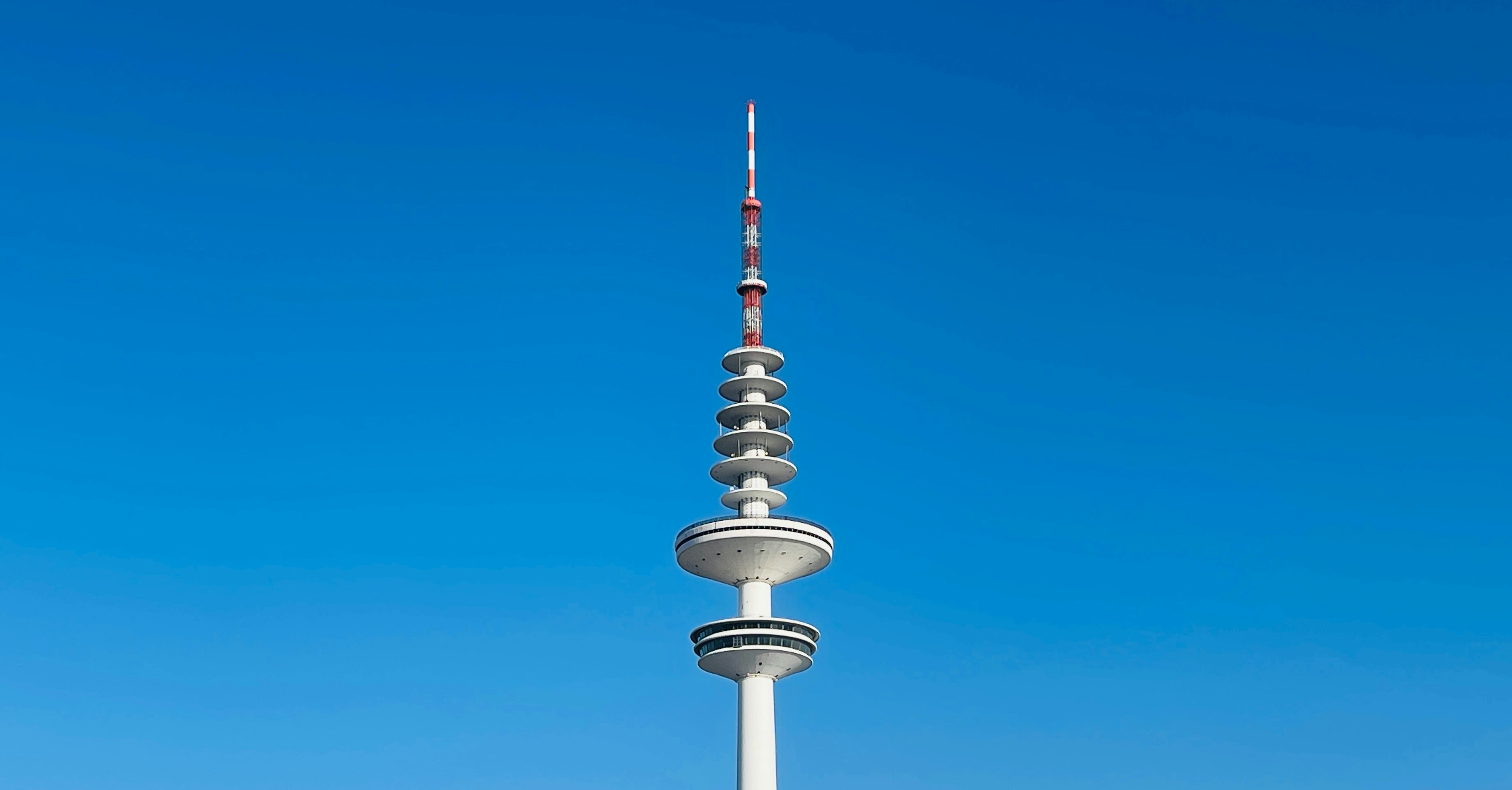 a tall white tower with a sky background