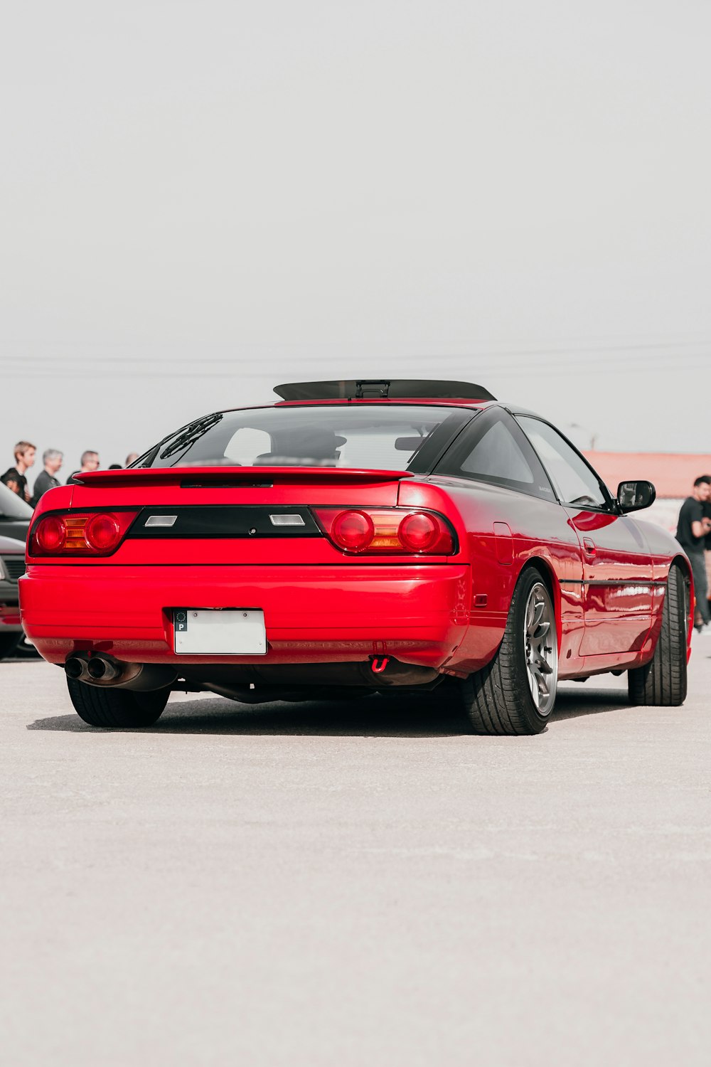 a red sports car parked in a parking lot