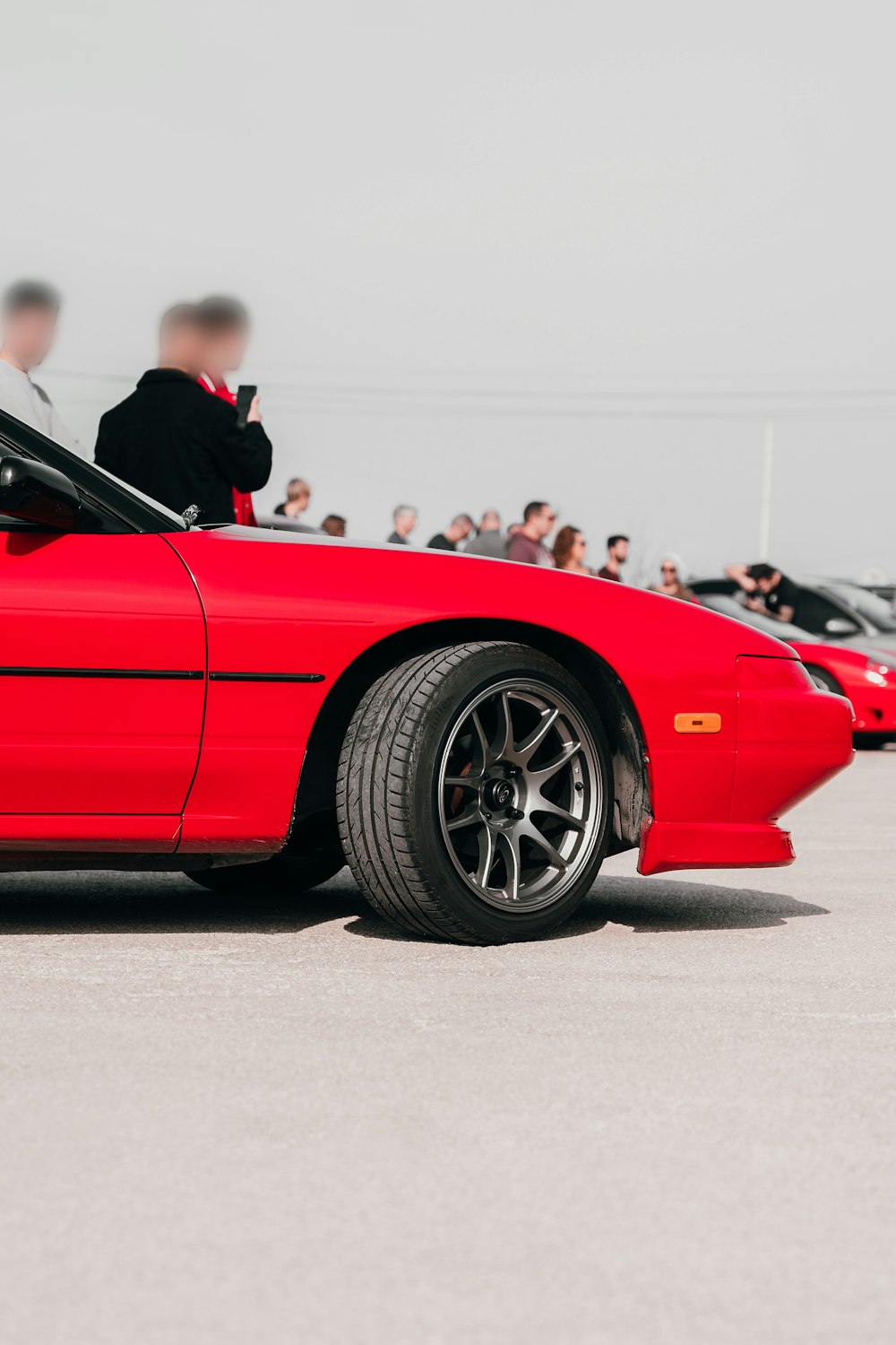 a red sports car parked in a parking lot