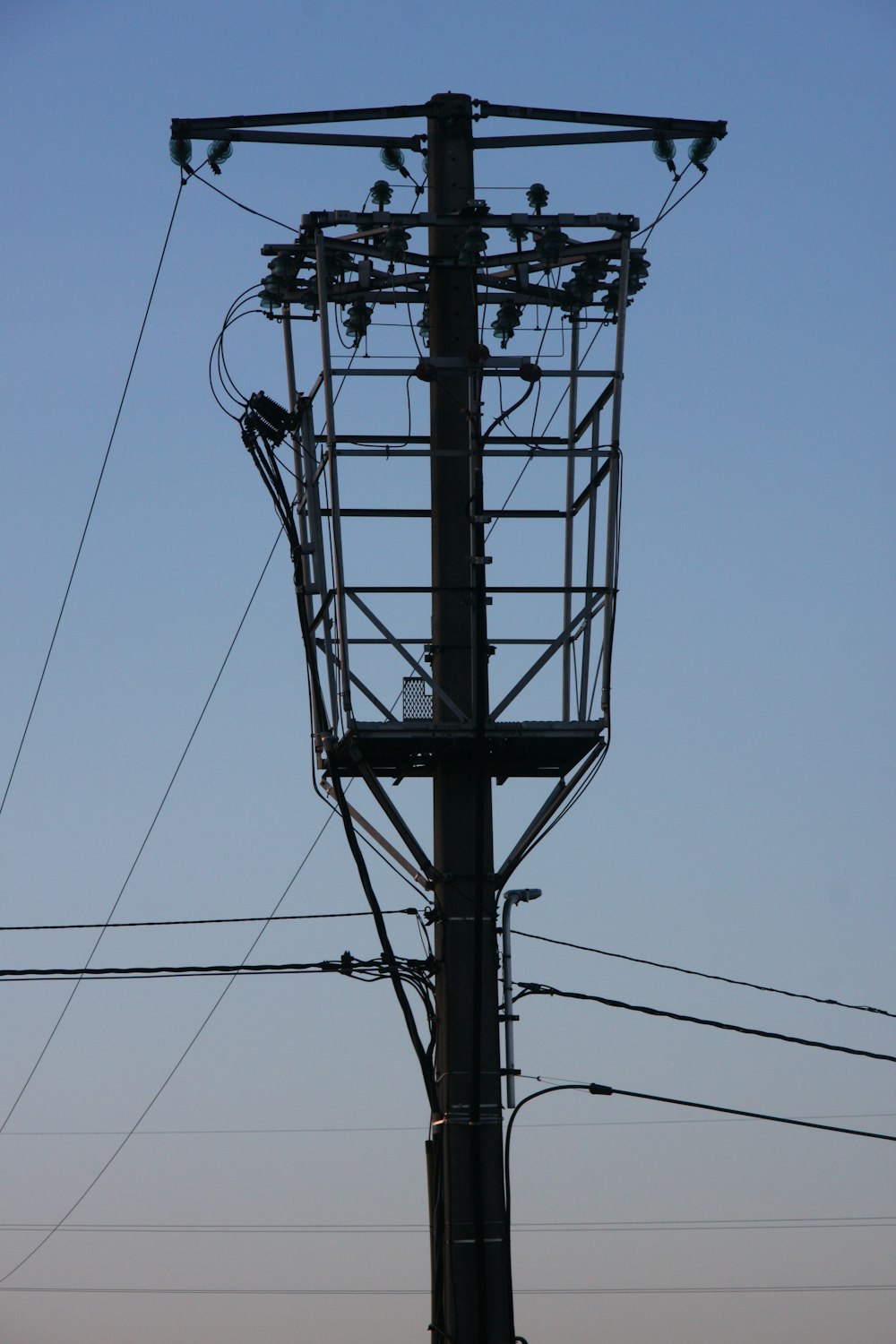 a tall tower with lots of wires on top of it