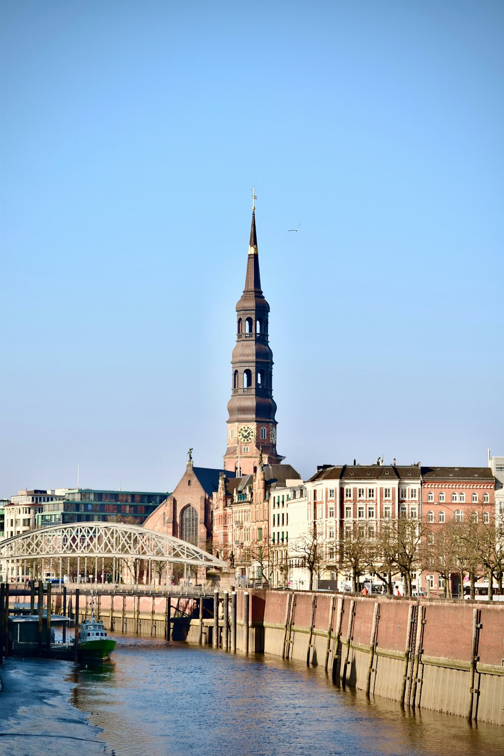 a large building with a tower next to a river