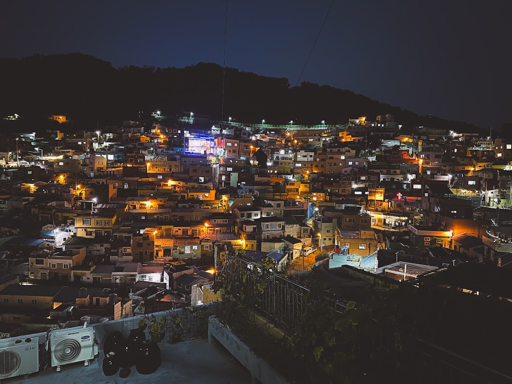 a view of a city at night from a hill