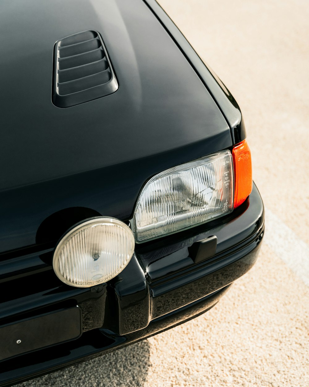 the front end of a black sports car