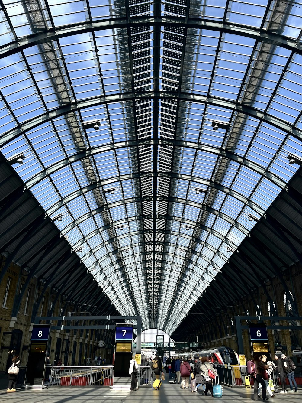 a train station with a glass ceiling and a skylight