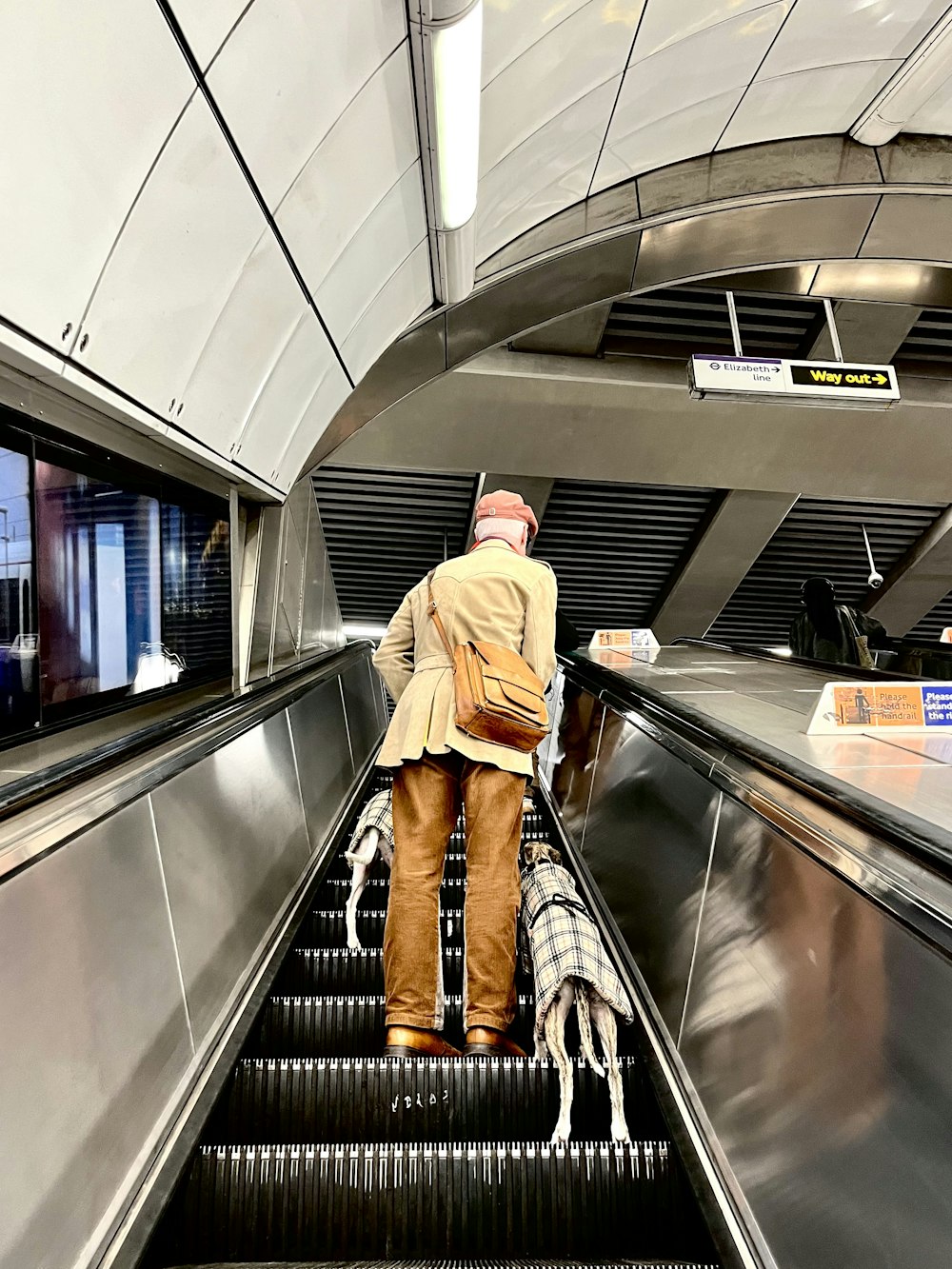 a man riding an escalator down an escalator