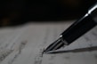 a pen is sitting on top of a piece of paper