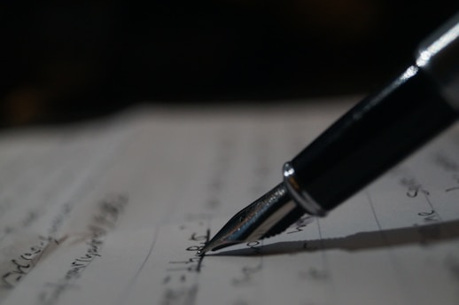 a pen is sitting on top of a piece of paper