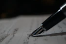 a pen is sitting on top of a piece of paper