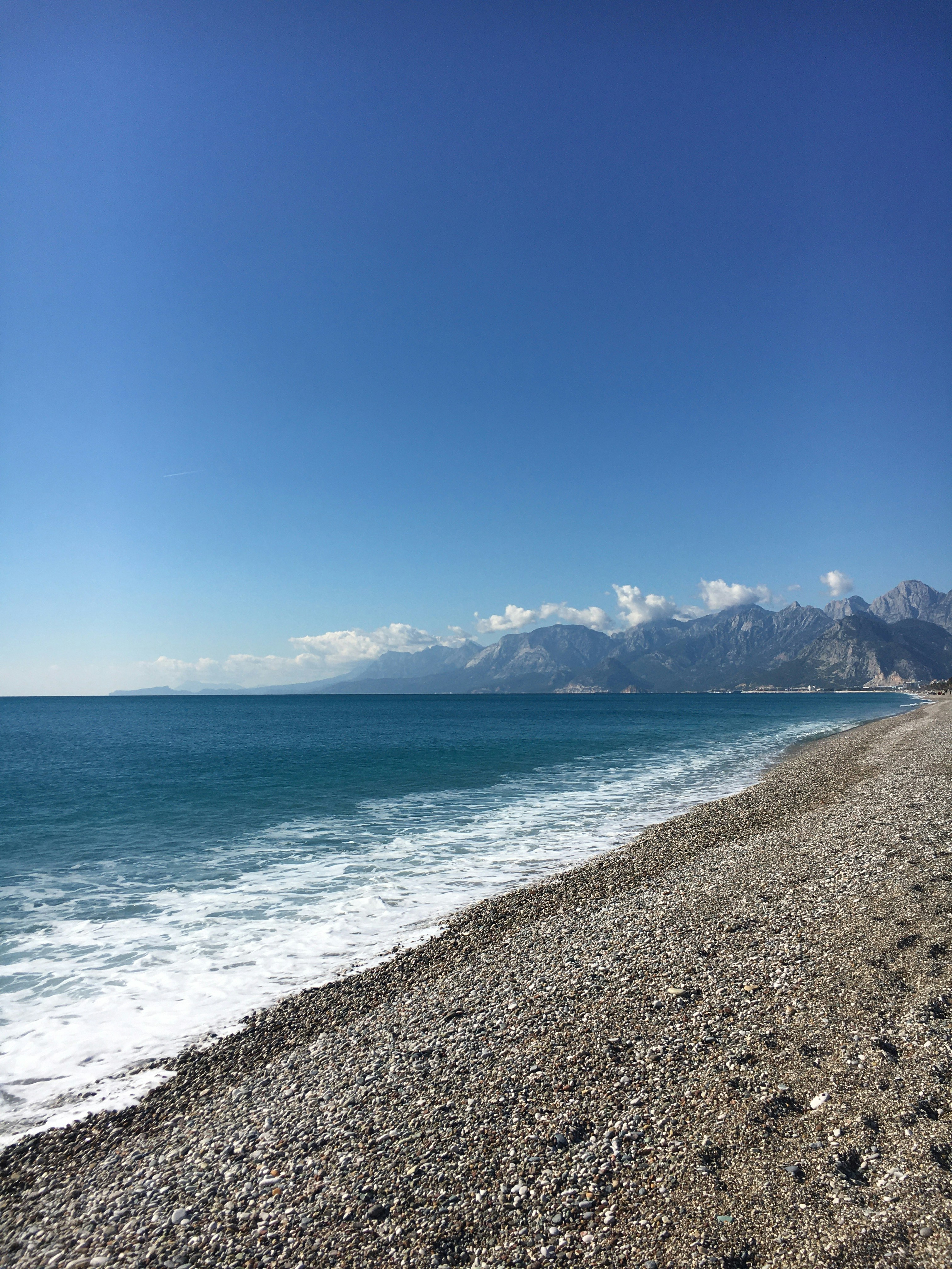a view of the ocean from a rocky beach
