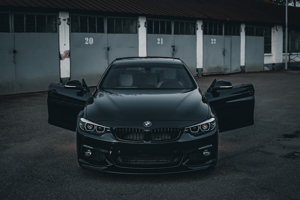 a black car parked in front of a building