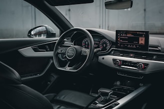 the interior of a car with a steering wheel and dashboard
