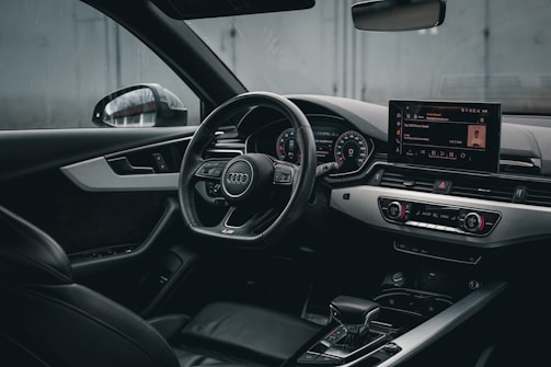 the interior of a car with a steering wheel and dashboard