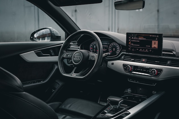 the interior of a car with a steering wheel and dashboard