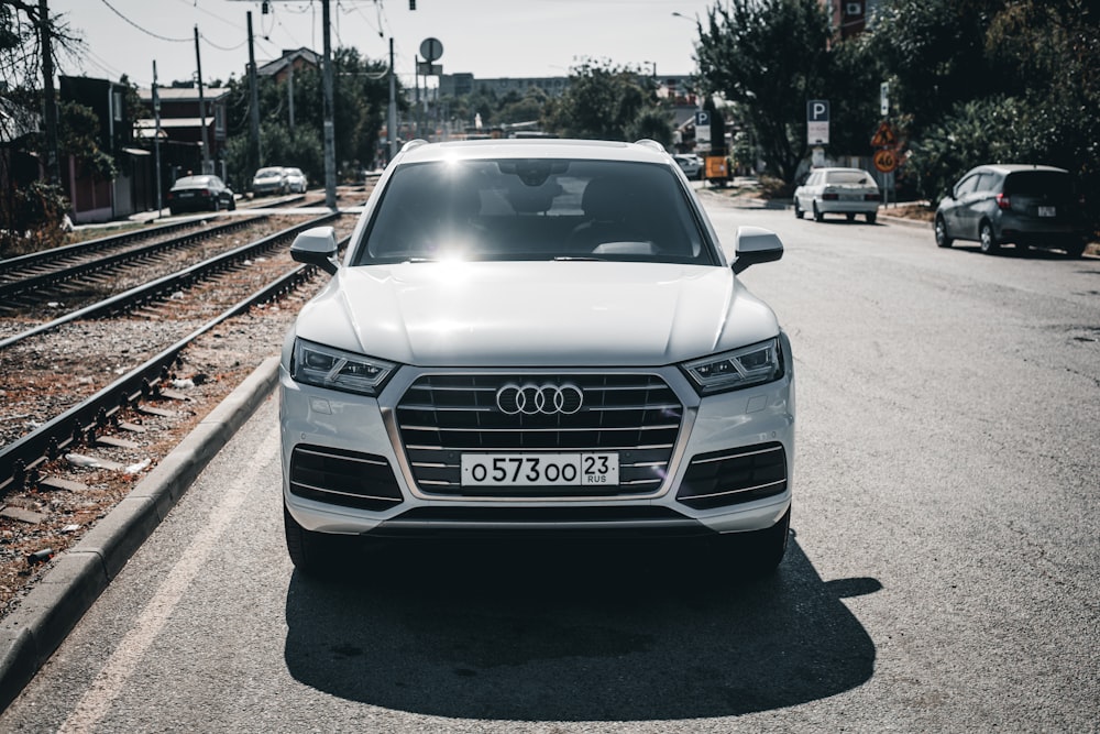 a white car parked on the side of the road