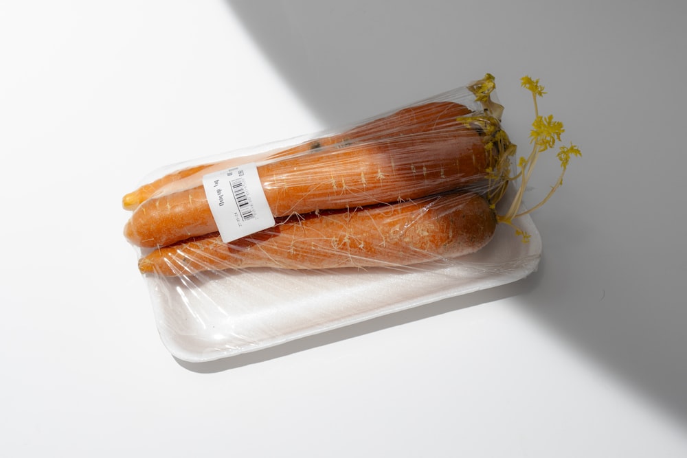 a package of carrots sitting on top of a white table