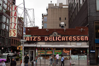 a group of people standing outside of a restaurant