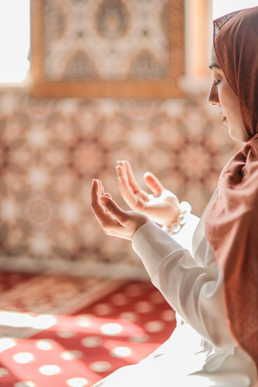 a woman in a hijab sitting on a bed