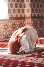 a person kneeling on a rug in a room