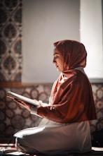 a statue of a woman reading a book