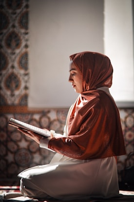 a statue of a woman reading a book