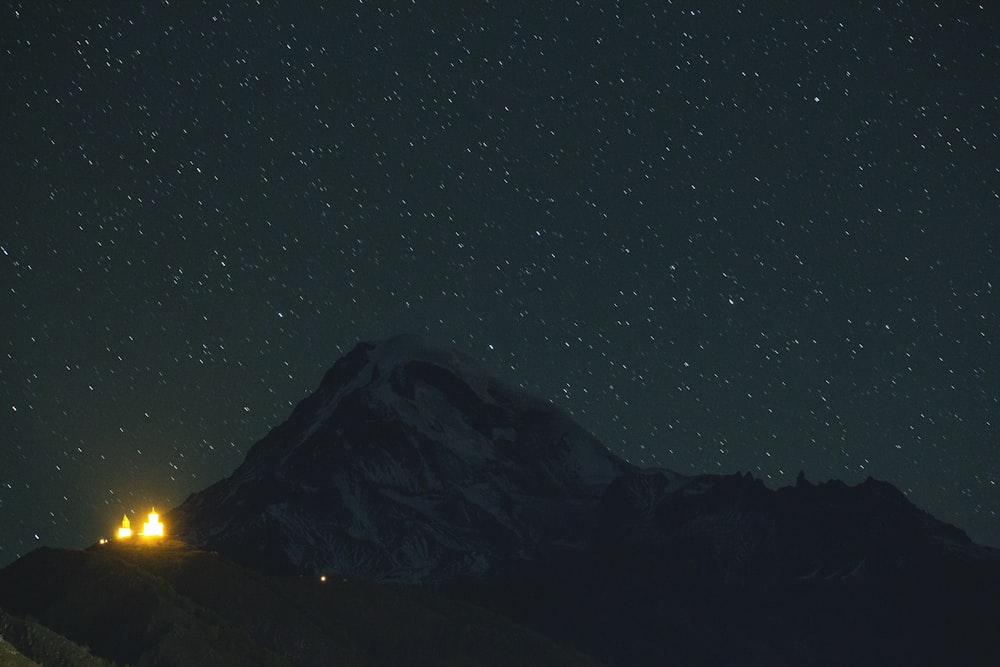 the night sky is full of stars above a mountain
