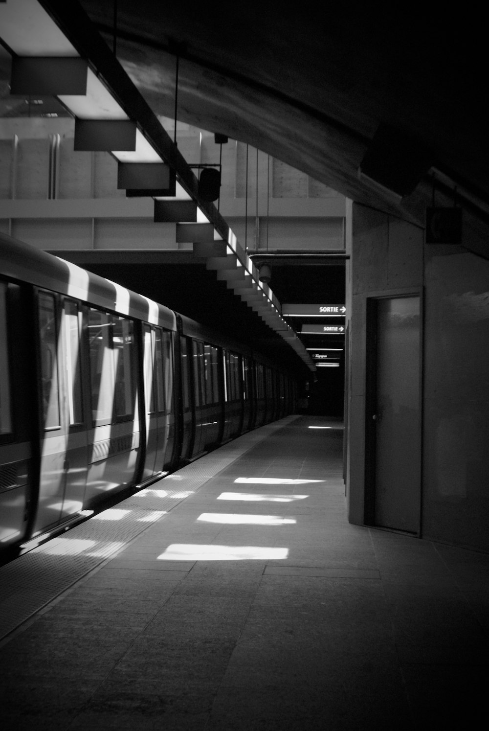 a subway train pulling into a train station