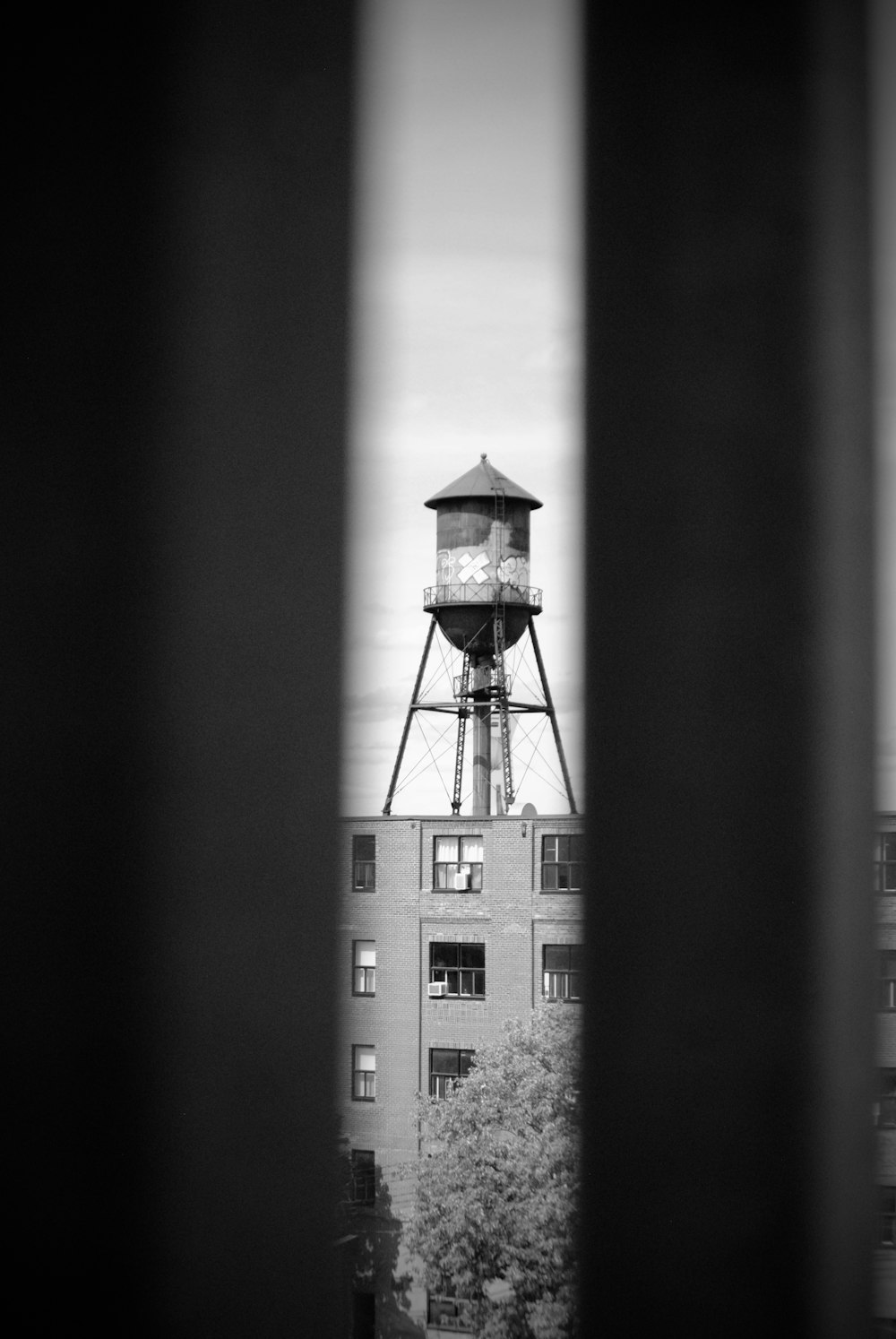 a black and white photo of a water tower