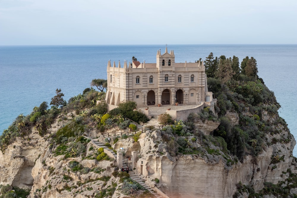 a castle on top of a cliff near the ocean