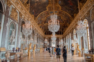 a large room with chandeliers and paintings on the walls
