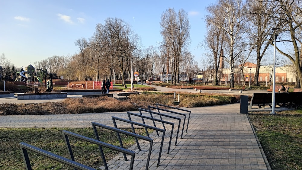 a row of benches sitting next to a park