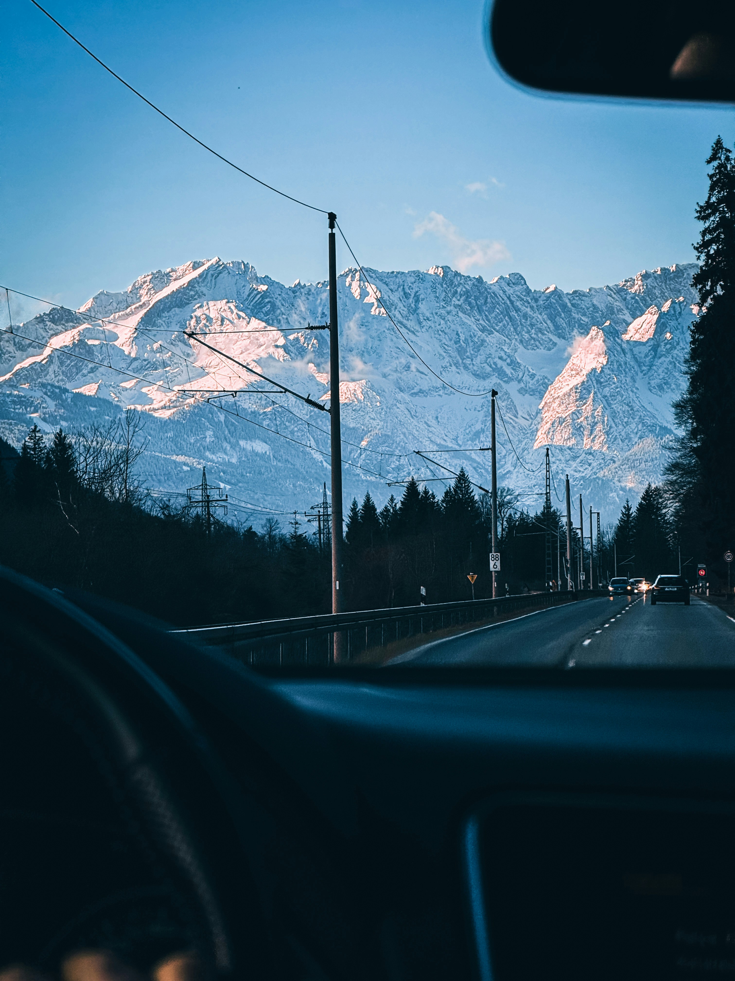 a view of a mountain range from inside a car