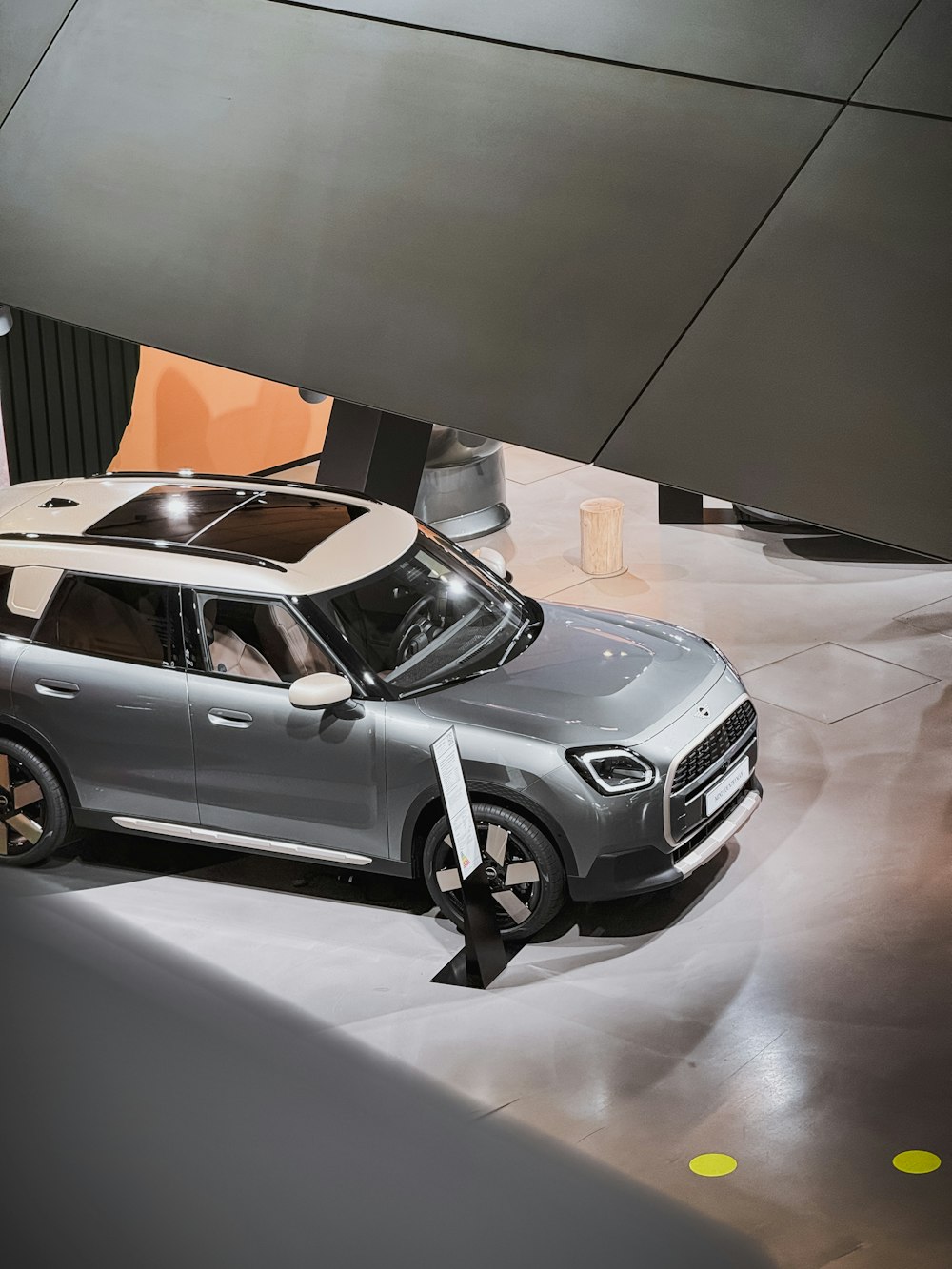 a silver car is on display at a show