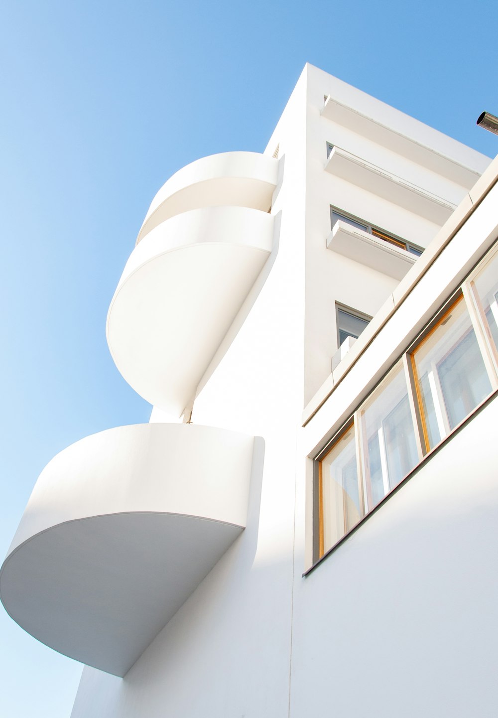 a tall white building with a clock on it's side