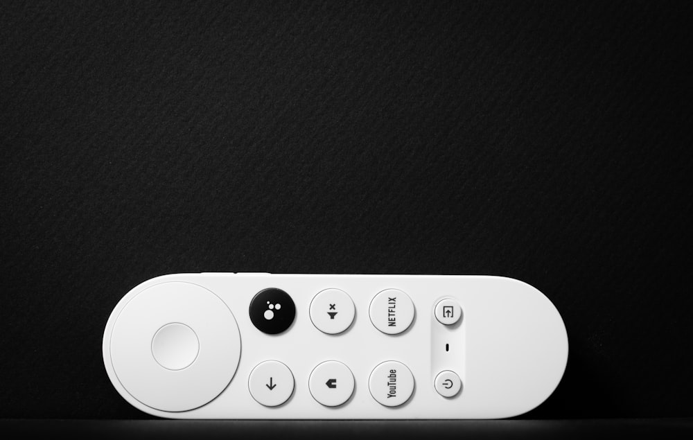 a white remote control sitting on top of a table