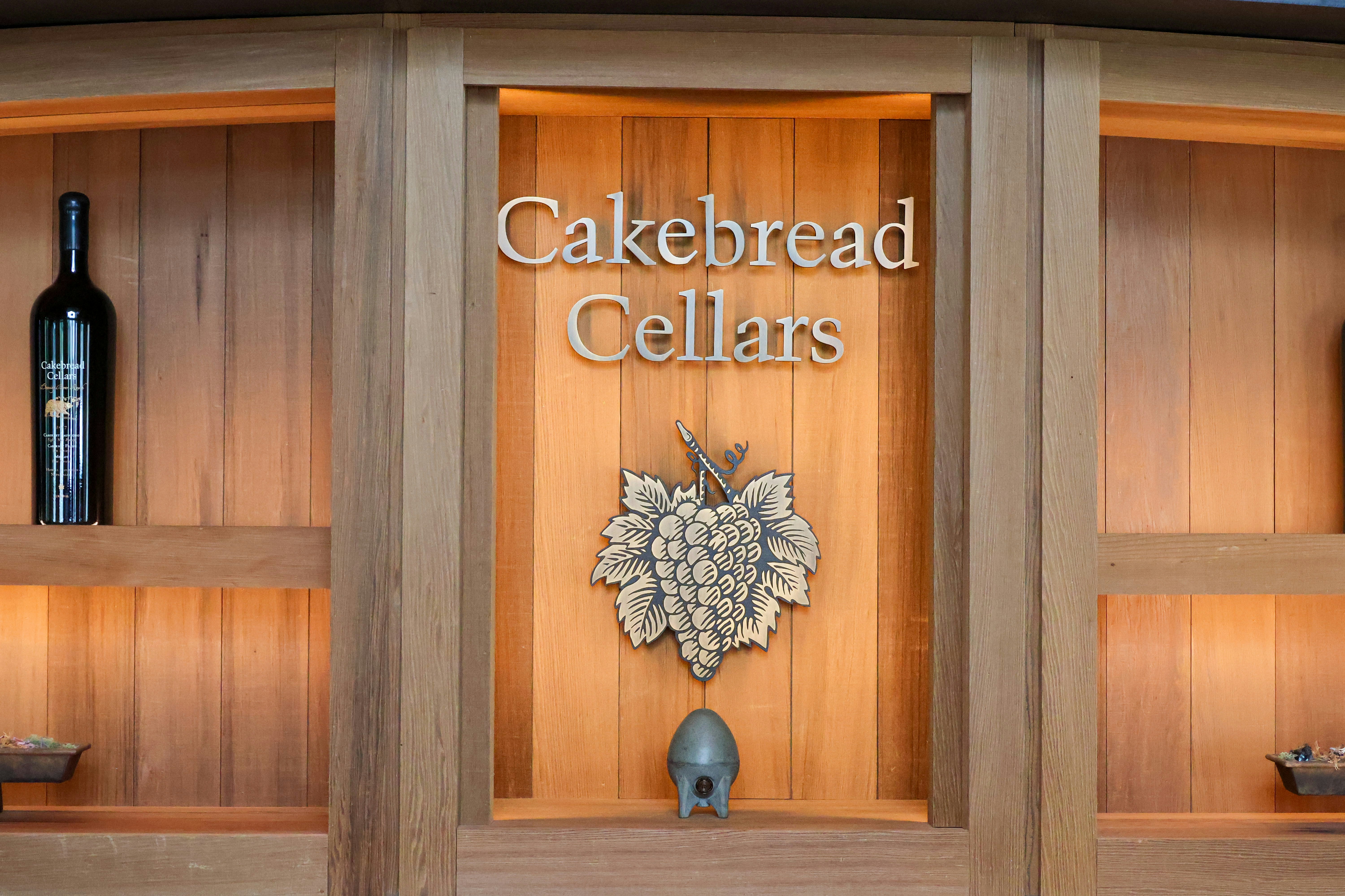 una vitrina con botellas de vino y un reloj