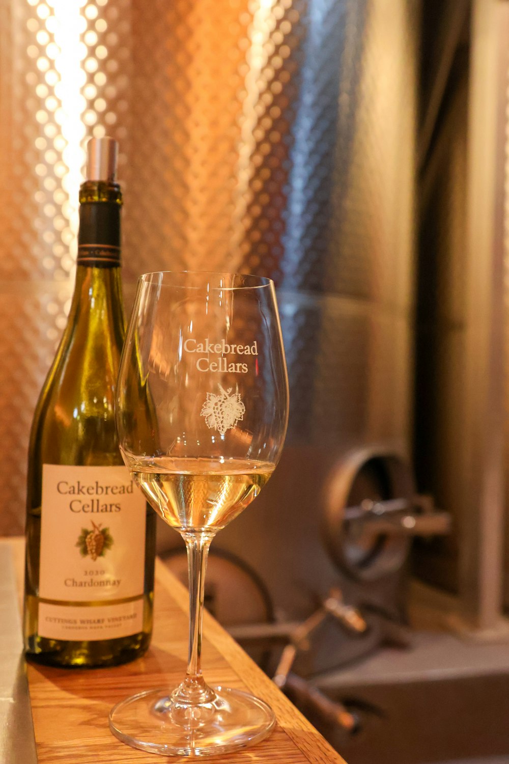 a bottle of wine and a glass on a counter