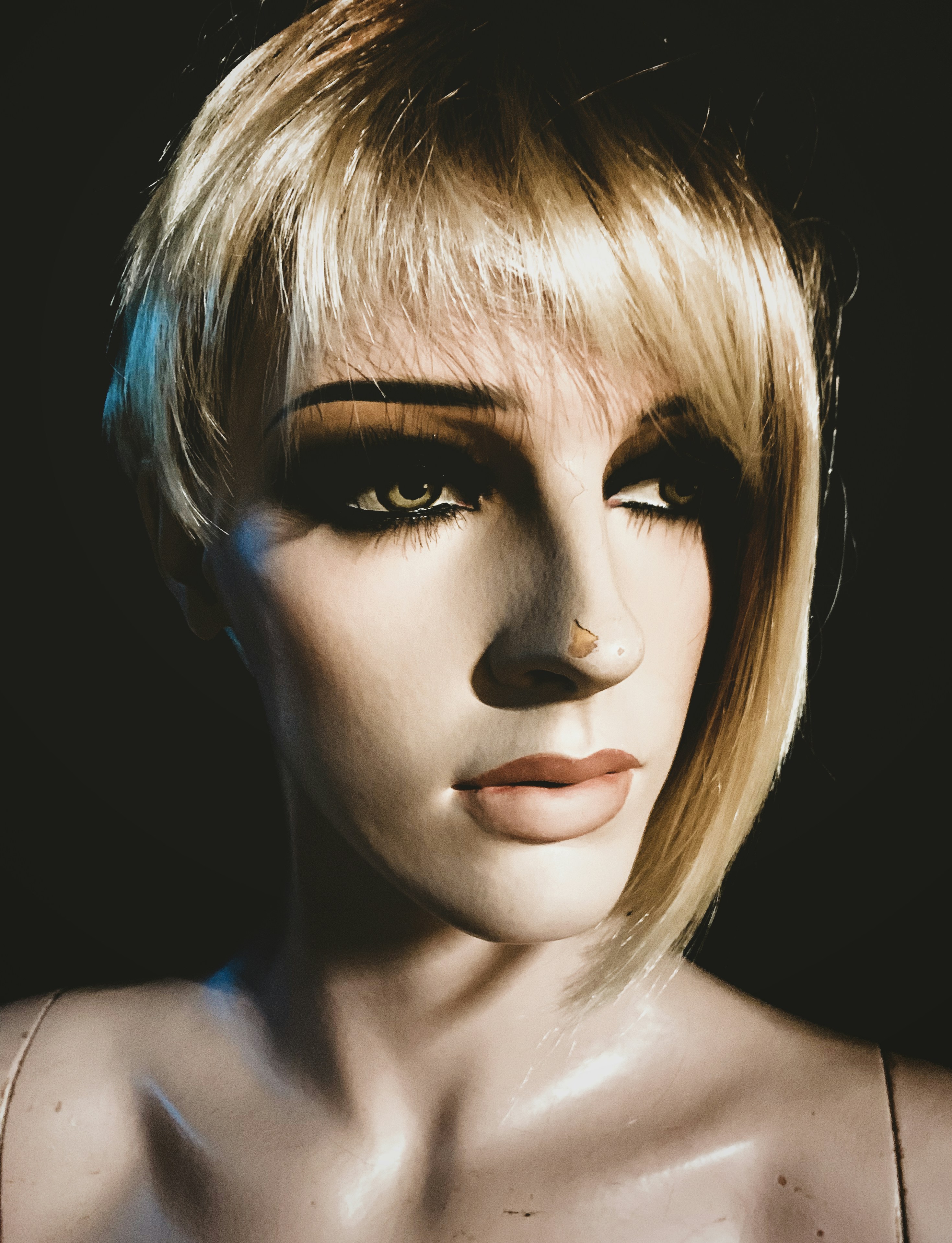 a close up of a mannequin's face with makeup