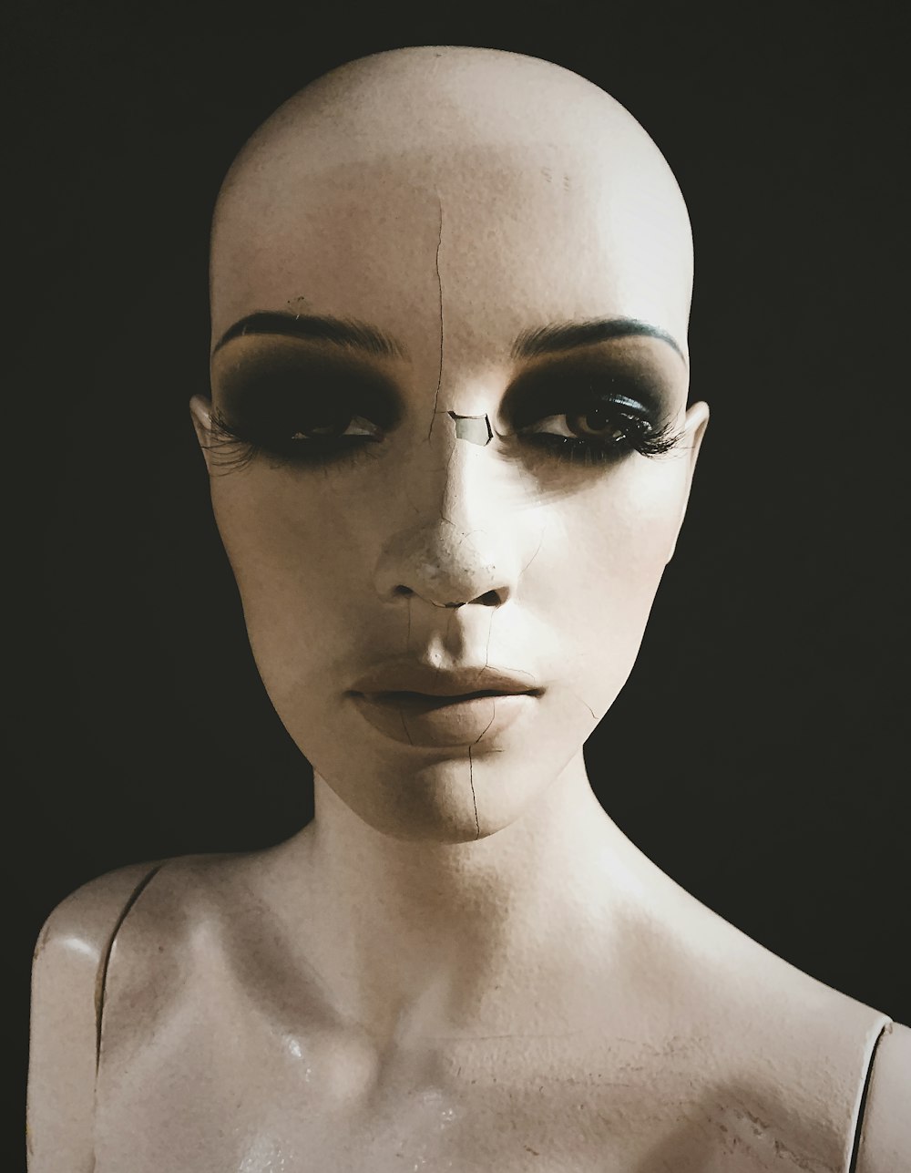 a white mannequin with a black eyeliner