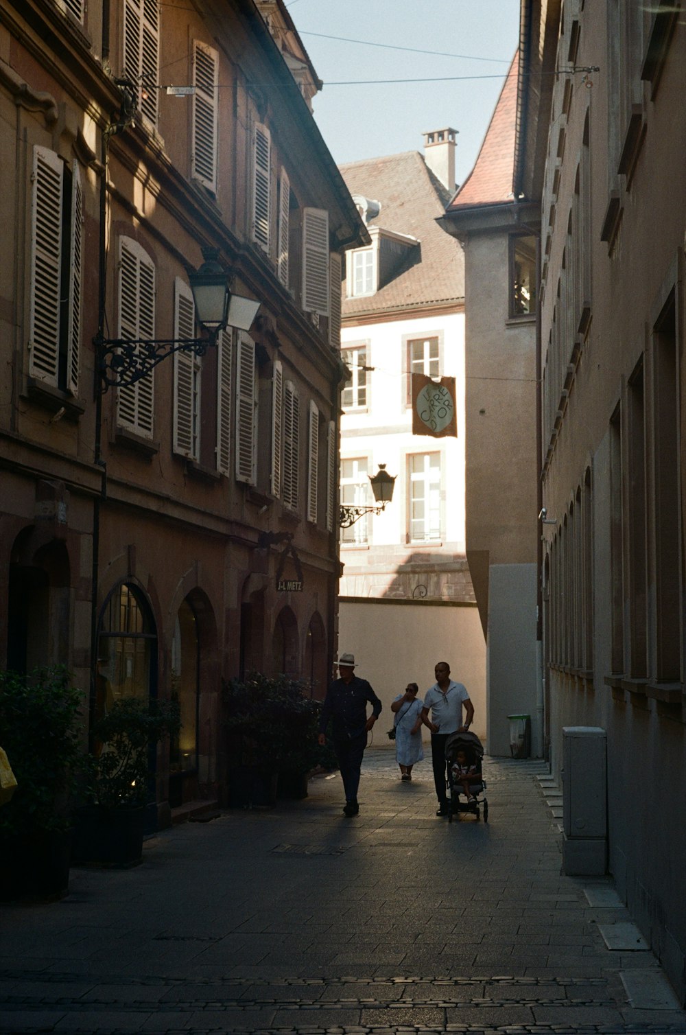 a couple of people that are walking down a street