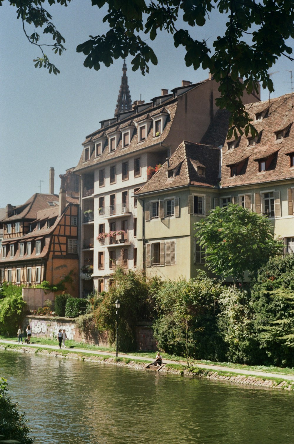 a body of water in front of a row of buildings