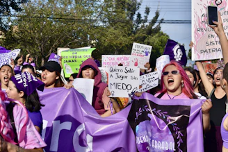 a group of people holding up signs and banners