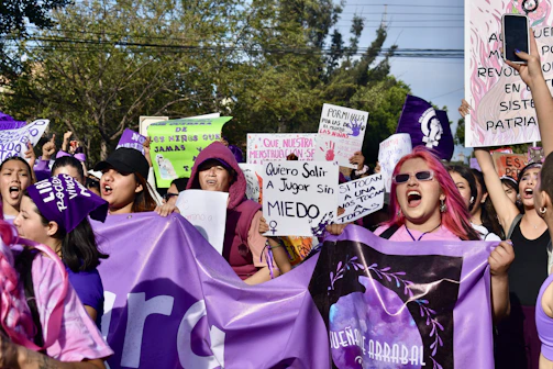 a group of people holding up signs and banners