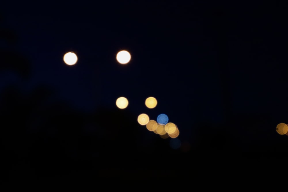 a blurry photo of street lights at night